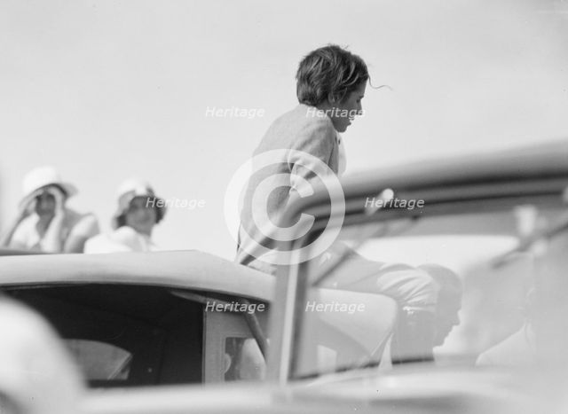 Mrs. Jack Bouvier, seated on a car, 1932. Creator: Arnold Genthe.