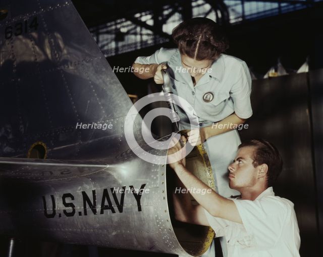 Mrs. Virginia Davis, a riveter in the assembly and repair department of the Naval air base..., 1942. Creator: Howard Hollem.