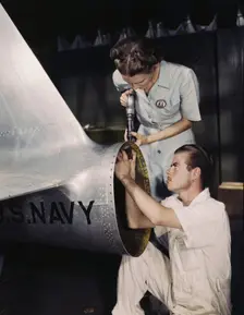 Mrs. Virginia Davis, a riveter in the assembly and repair department of the Naval Air Base..., 1942. Creator: Howard Hollem