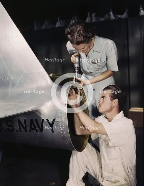 Mrs. Virginia Davis, a riveter in the assembly and repair department of the Naval Air Base..., 1942. Creator: Howard Hollem.