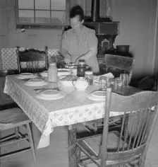 Mrs. Wardlow bakes her own bread in her dugout house, Dead Ox Flat, Oregon, 1939. Creator: Dorothea Lange