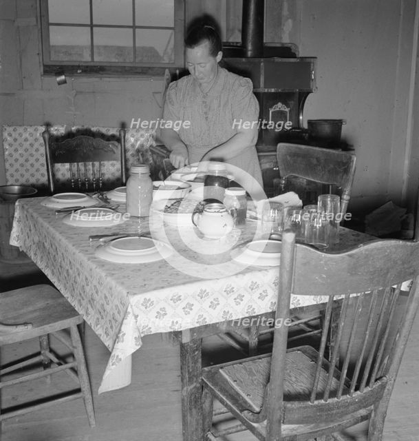 Mrs. Wardlow bakes her own bread in her dugout house, Dead Ox Flat, Oregon, 1939. Creator: Dorothea Lange.