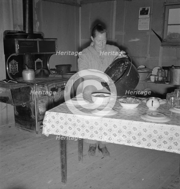 Mrs. Wardlow getting dinner after church in her basement..., Dead Ox Flat, Oregon, 1939. Creator: Dorothea Lange.