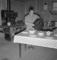 Mrs. Wardlow getting dinner after church in her basement..., Dead Ox Flat, Oregon, 1939. Creator: Dorothea Lange