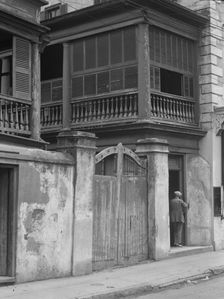 Multi-story house behind gated wall, New Orleans or Charleston, South Carolina, c1920-1926. Creator: Arnold Genthe