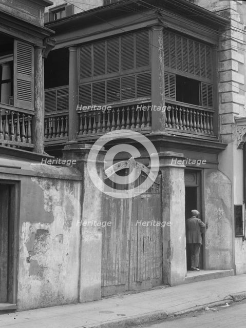 Multi-story house behind gated wall, New Orleans or Charleston, South Carolina, c1920-1926. Creator: Arnold Genthe.