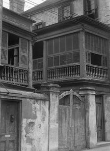 Multi-story house behind wall with gate, Charleston, South Carolina, between 1920 and 1926. Creator: Arnold Genthe