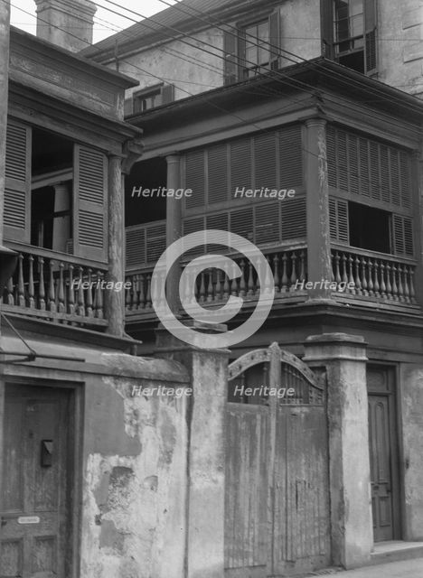 Multi-story house behind wall with gate, Charleston, South Carolina, between 1920 and 1926. Creator: Arnold Genthe.