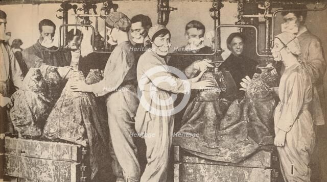 'Munition Workers Wearing Respirators While Filling Sells with Trinitrotoluene (T.N.T.)', c1916, (19 Artist: Unknown.