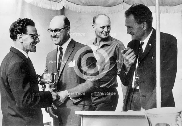 Murray Walker in 1963, Lord Montagu in background. Creator: Unknown.