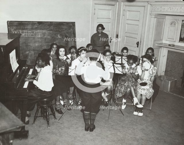 Music classes, tambourines and piano, 1938. Creator: Aubrey Pollard.