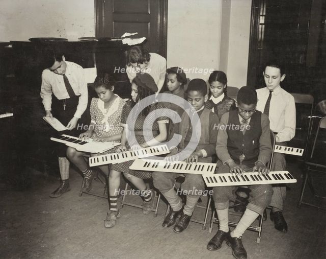 Music classes, keyboards, 1938. Creator: Aubrey Pollard.