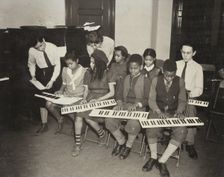 Music classes, keyboards, 1938. Creator: Aubrey Pollard