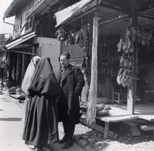 Muslim women talking to a man, Bosnia-Hercegovina, Yugoslavia, 1939. Creator: Unknown