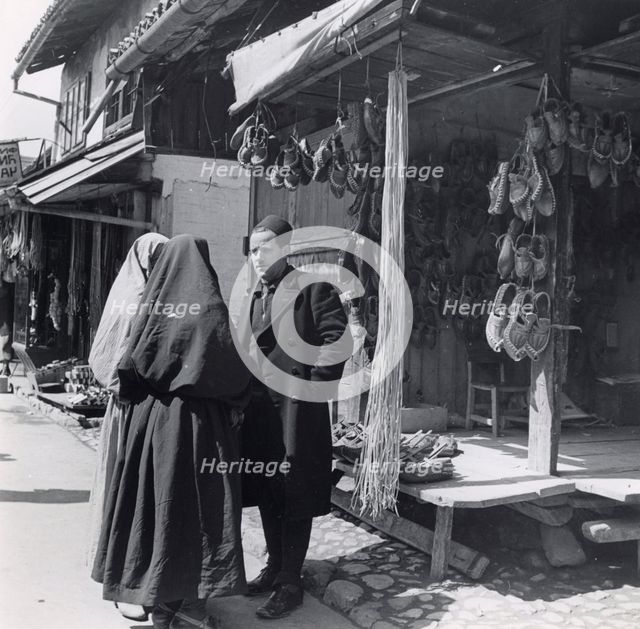 Muslim women talking to a man, Bosnia-Hercegovina, Yugoslavia, 1939. Creator: Unknown.