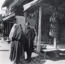 Muslim women talking to a man, Bosnia-Hercegovina, Yugoslavia, 1939