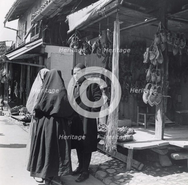 Muslim women talking to a man, Bosnia-Hercegovina, Yugoslavia, 1939. Artist: Unknown