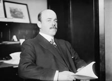 N. Longworth seated with book, 1911. Creator: Bain News Service