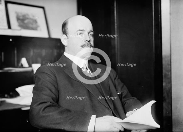 N. Longworth seated with book, 1911. Creator: Bain News Service.
