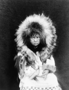Noatak child, three-quarter length portrait, seated, facing front, c1929. Creator: Edward Sheriff Curtis