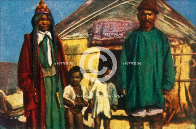 Nomads outside their yurt, west Mongolia, c1928. Creator: Unknown.