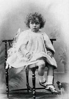 Nora Schuster aged 3, seated, facing forwards, c1895. Creator: Mrs Fred Wilkinson