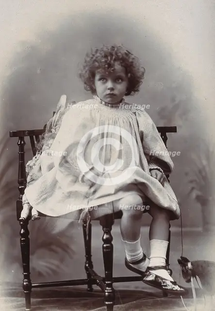 Nora Schuster aged 3, seated, facing forwards, c1895. Creator: Mrs Fred Wilkinson.