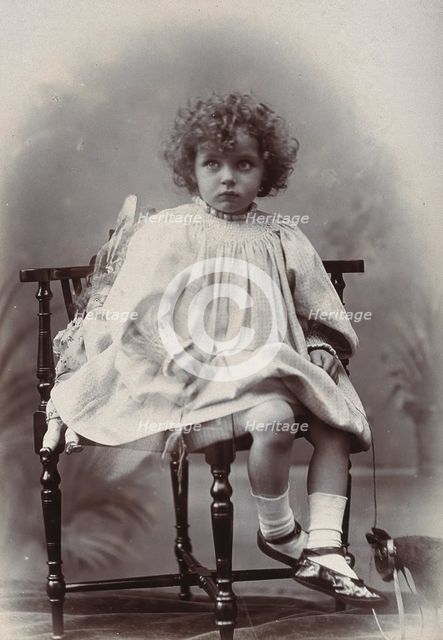 Nora Schuster aged 3, seated, facing forwards, c1895. Creator: Mrs Fred Wilkinson.