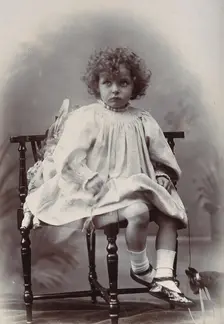 Nora Schuster aged 3, seated, facing forwards, c1895. Creator: Mrs Fred Wilkinson