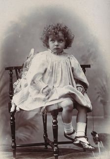 Nora Schuster aged 3, seated, facing forwards, c1895. Creator: Mrs Fred Wilkinson