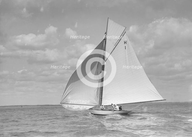 'Norman' (H1), an early 8 Metre class yacht sailing downwind, 1911. Creator: Kirk & Sons of Cowes.