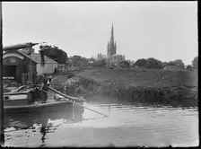 Norwich Cathedral from Pull's Ferry, with men on a boat in the foreground, Norwich, Norfolk, 1920-38 Creator: George R Long