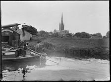 Norwich Cathedral from Pull's Ferry, with men on a boat in the foreground, Norwich, Norfolk, 1920-38 Creator: George R Long