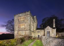 North Lees Hall from the south-east with the windows illuminated, Hathersage, Derbyshire, 2025. Creator: Alun Bull