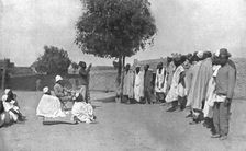 Nos recrues de trois parties du monde; En Afrique occidentale: palabre aux recrues..., 1916 (1924) Creator: Unknown