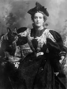 Natalie Barney seated with dog, 1910. Creator: Bain News Service