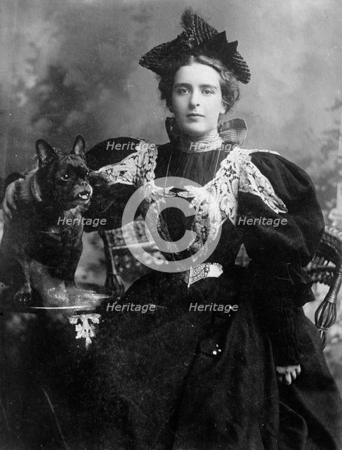 Natalie Barney seated with dog, 1910. Creator: Bain News Service.