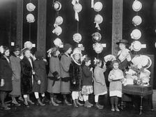 Natalie Stewart Distributing hats to poor children, between c1915 and c1920. Creator: Bain News Service