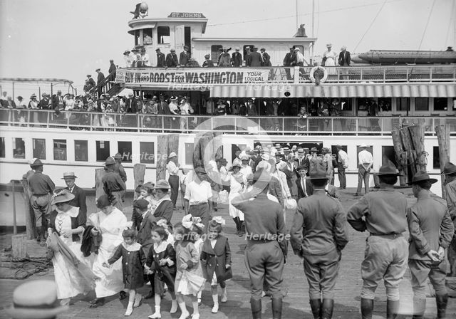National Guard of D.C., Women And Children Leaving Boat On Return of M. And M. And N.G., 1916. Creator: Harris & Ewing.