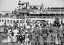 National Guard of D.C., Women And Children Leaving Boat On Return of M. And M. And N.G., 1916. Creator: Harris & Ewing