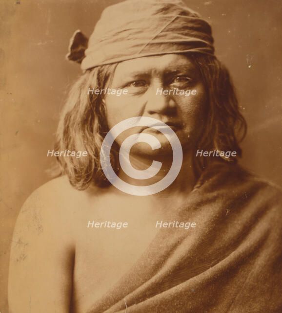 Native man, head-and-shoulders portrait, facing front, c1903. Creator: Edward Sheriff Curtis.
