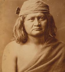 Native man, head-and-shoulders portrait, facing front, c1903. Creator: Edward Sheriff Curtis