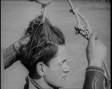 Native American Man Having a Rope Tied Into His Hair, 1921. Creator: British Pathe Ltd