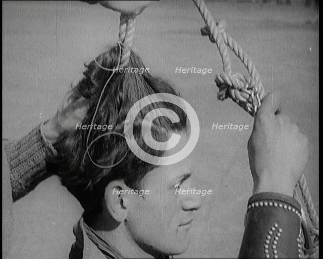 Native American Man Having a Rope Tied Into His Hair, 1921. Creator: British Pathe Ltd.