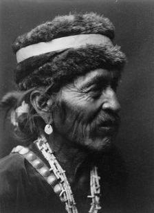 Navajo with fur cap, c1905. Creator: Edward Sheriff Curtis