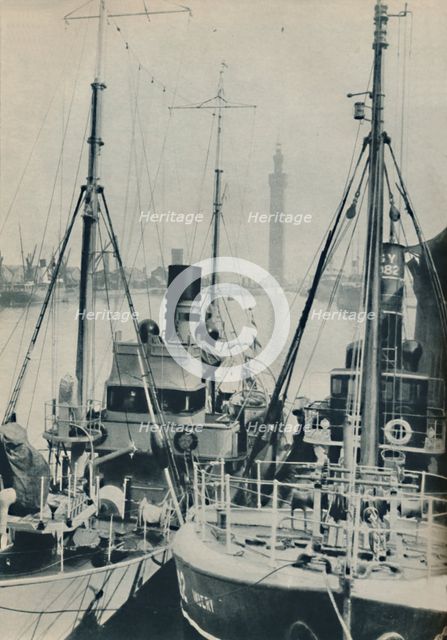 'Naval Trawler, HMS Liffy alongside a Grimsby fishing vessel in Grimsby Docks', 1937. Artist: Unknown.