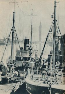 Naval Trawler, HMS Liffy alongside a Grimsby fishing vessel in Grimsby Docks 1937