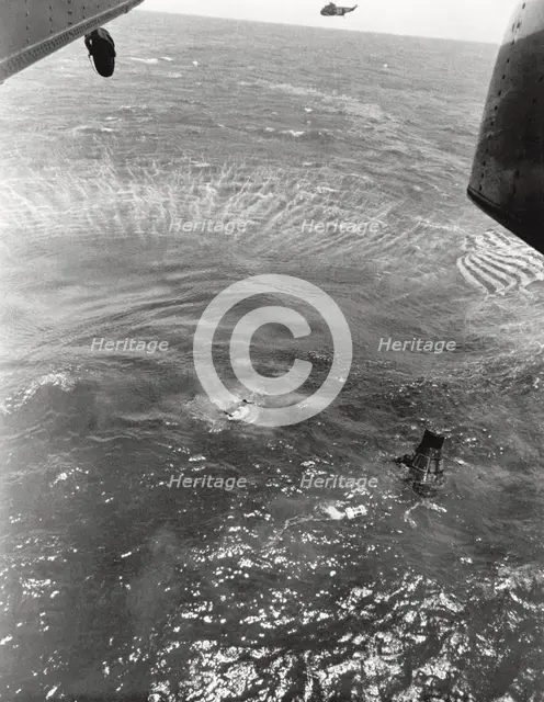 Navy frogmen swim to spacecraft to begin retrieval, Pacific Ocean, 1963. Creator: NASA.