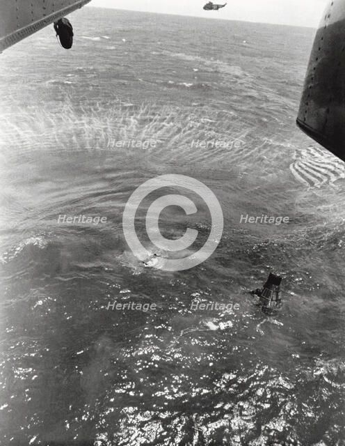 Navy frogmen swim to spacecraft to begin retrieval, Pacific Ocean, 1963. Creator: NASA.