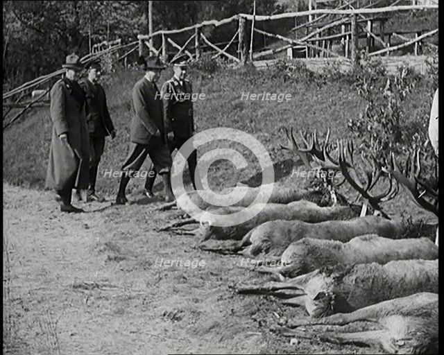 Nazi Officer Hermann Goering in Hunting Dress Showing His Colleagues a Line of Deer He Has..., 1931. Creator: British Pathe Ltd.